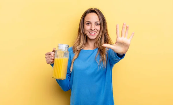 Pretty Woman Smiling Looking Friendly Showing Number Five Orange Juice — Zdjęcie stockowe