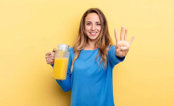 Pretty Woman Smiling Looking Friendly Showing Number Four Orange Juice — Stock fotografie