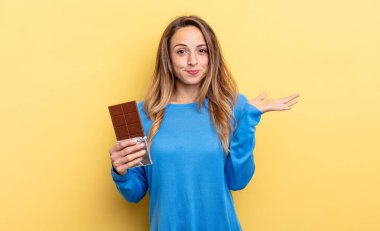 pretty woman feeling puzzled and confused and doubting. chocolate concept