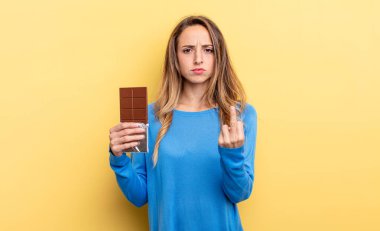pretty woman feeling angry, annoyed, rebellious and aggressive. chocolate concept