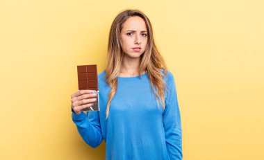 pretty woman feeling sad, upset or angry and looking to the side. chocolate concept