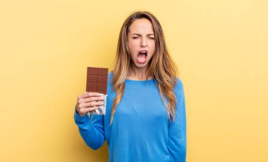 pretty woman shouting aggressively, looking very angry. chocolate concept