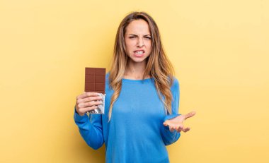 pretty woman looking angry, annoyed and frustrated. chocolate concept