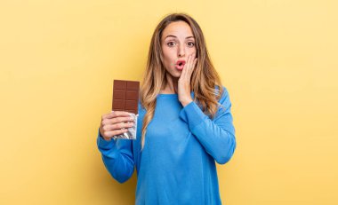 pretty woman feeling shocked and scared. chocolate concept