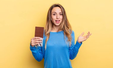 pretty woman feeling happy, surprised realizing a solution or idea. chocolate concept