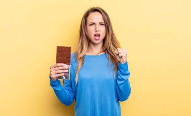 pretty woman shouting aggressively with an angry expression. chocolate concept