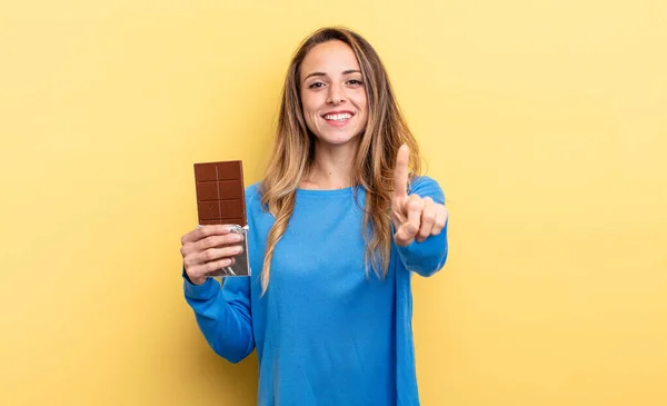 Pretty Woman Smiling Proudly Confidently Making Number One Chocolate Concept — стоковое фото