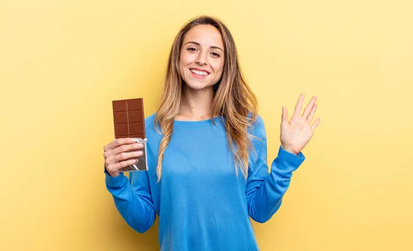 Pretty Woman Smiling Happily Waving Hand Welcoming Greeting You Chocolate — стоковое фото