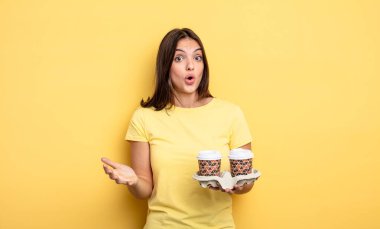 pretty woman feeling extremely shocked and surprised. take away coffee concept