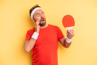 middle age man feeling happy, excited and surprised. ping pong concept