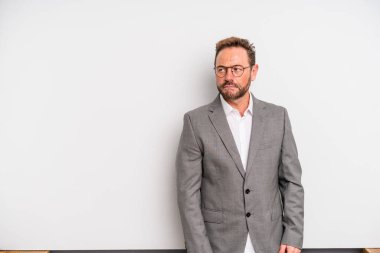 middle age man feeling sad, upset or angry and looking to the side. businessman concept