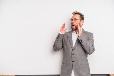 middle age man feeling happy, excited and surprised. businessman concept