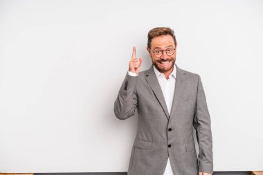 middle age man feeling like a happy and excited genius after realizing an idea. businessman concept