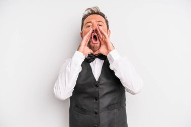 middle age man feeling happy,giving a big shout out with hands next to mouth. waiter concept