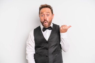 middle age man looking astonished in disbelief. waiter concept