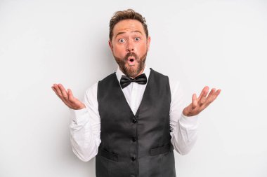 middle age man amazed, shocked and astonished with an unbelievable surprise. waiter concept