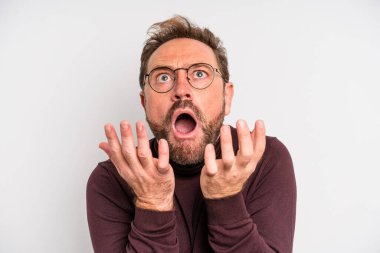middle age man looking desperate, frustrated and stressed