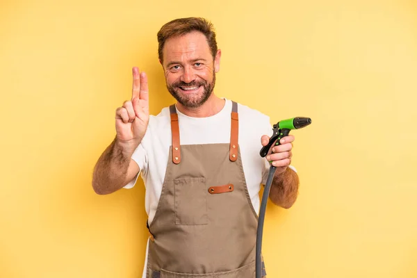 Middle Age Man Smiling Looking Friendly Showing Number Two Gardener — Stock Photo, Image