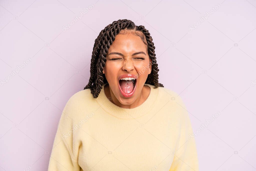 black afro woman shouting aggressively, looking very angry