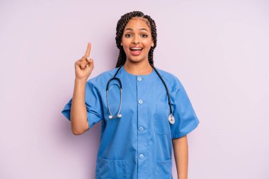 Siyah afro kadın bir fikri fark ettikten sonra mutlu ve heyecanlı bir dahi gibi hissediyor. hemşire konsepti