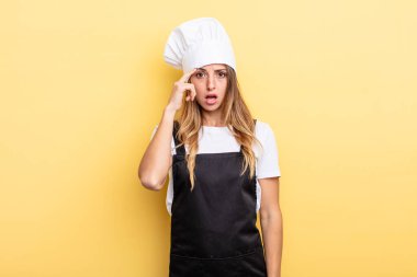 pretty woman looking surprised, realizing a new thought, idea or concept. chef concept