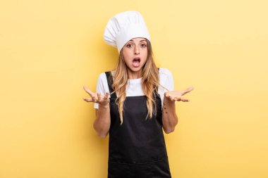 pretty woman feeling extremely shocked and surprised. chef concept