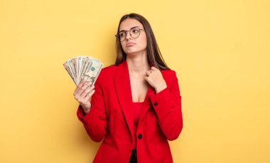 pretty woman feeling stressed, anxious, tired and frustrated. dollar banknotes concept