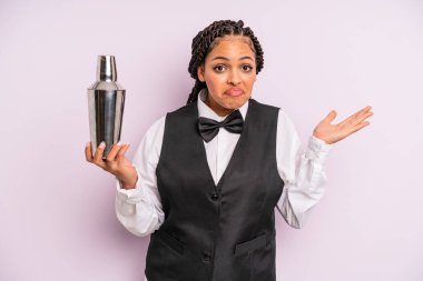 afro black woman feeling puzzled and confused and doubting. waiter with a cocktail