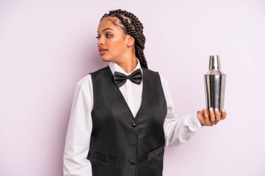 afro black woman on profile view thinking, imagining or daydreaming. waiter with a cocktail