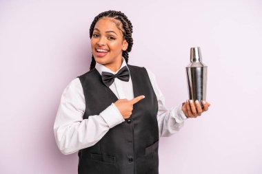 afro black woman looking excited and surprised pointing to the side. waiter with a cocktail