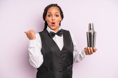afro black woman looking astonished in disbelief. waiter with a cocktail