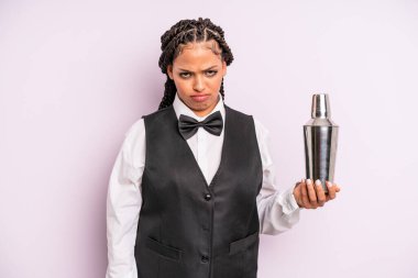afro black woman feeling sad and whiney with an unhappy look and crying. waiter with a cocktail