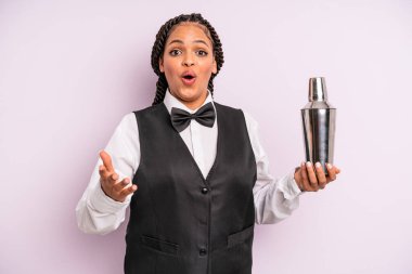 afro black woman amazed, shocked and astonished with an unbelievable surprise. waiter with a cocktail