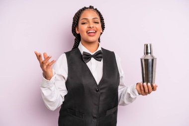 afro black woman feeling happy, surprised realizing a solution or idea. waiter with a cocktail