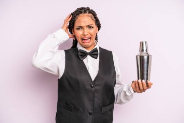 afro black woman screaming with hands up in the air. waiter with a cocktail