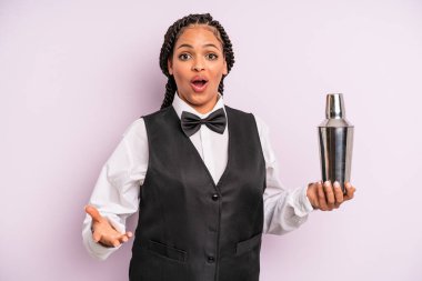 afro black woman feeling extremely shocked and surprised. waiter with a cocktail