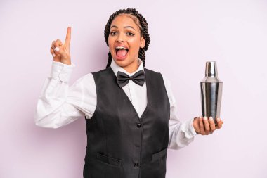 afro black woman feeling like a happy and excited genius after realizing an idea. waiter with a cocktail