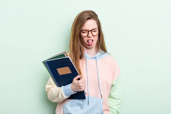 赤毛の女はうんざりしていらいらして舌を出してる 学生のコンセプト — ストック写真