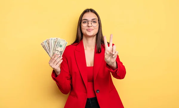 Pretty Woman Smiling Looking Friendly Showing Number Two Dollar Banknotes — Foto Stock