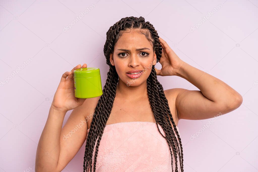 afro black woman feeling stressed, anxious or scared, with hands on head. hair treatment concept