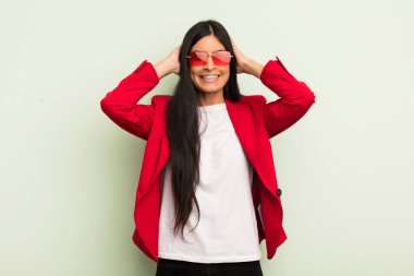 Genç ve güzel İspanyol kadın stresli, endişeli ya da korkmuş hissediyor. Elleri başının üstünde. İş kadını kavramı