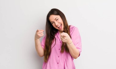 pretty caucasian woman feeling happy, cool, satisfied, relaxed and successful, pointing at camera, choosing you