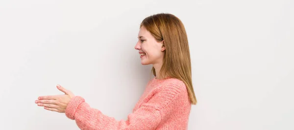 赤い頭の可愛い女性が笑顔で挨拶し握手を交わして成功裏に取引を締めくくり協力の概念 — ストック写真