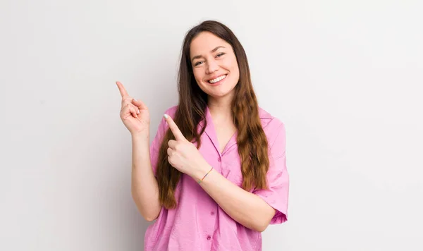 Pretty Caucasian Woman Smiling Happily Pointing Side Upwards Both Hands — стоковое фото