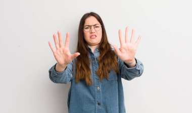 pretty caucasian woman feeling terrified, backing off and screaming in horror and panic, reacting to a nightmare