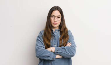 pretty caucasian woman feeling displeased and disappointed, looking serious, annoyed and angry with crossed arms