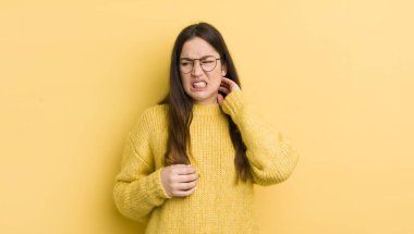 pretty caucasian woman feeling stressed, frustrated and tired, rubbing painful neck, with a worried, troubled look