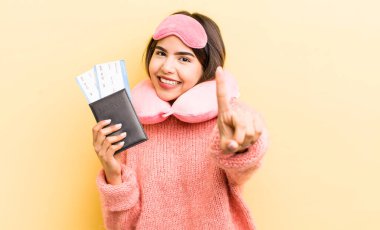 Güzel İspanyol kız gülümsüyor ve arkadaş canlısı görünüyor, bir numarayı gösteriyor. uçuş yolcu kavramı