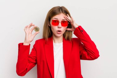 kızıl saçlı güzel kız mutlu, şaşkın ve şaşırmış görünüyor. Bitcoin konsepti