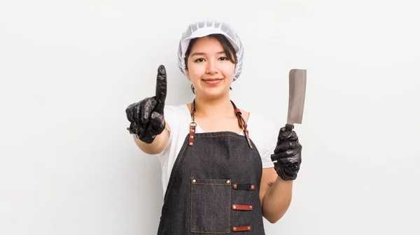 Pretty Hispanic Girl Smiling Looking Friendly Showing Number One Butcher — Stock Photo, Image